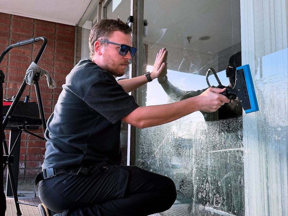 Installer applying protective film to commercial storefront glass in Los Angeles